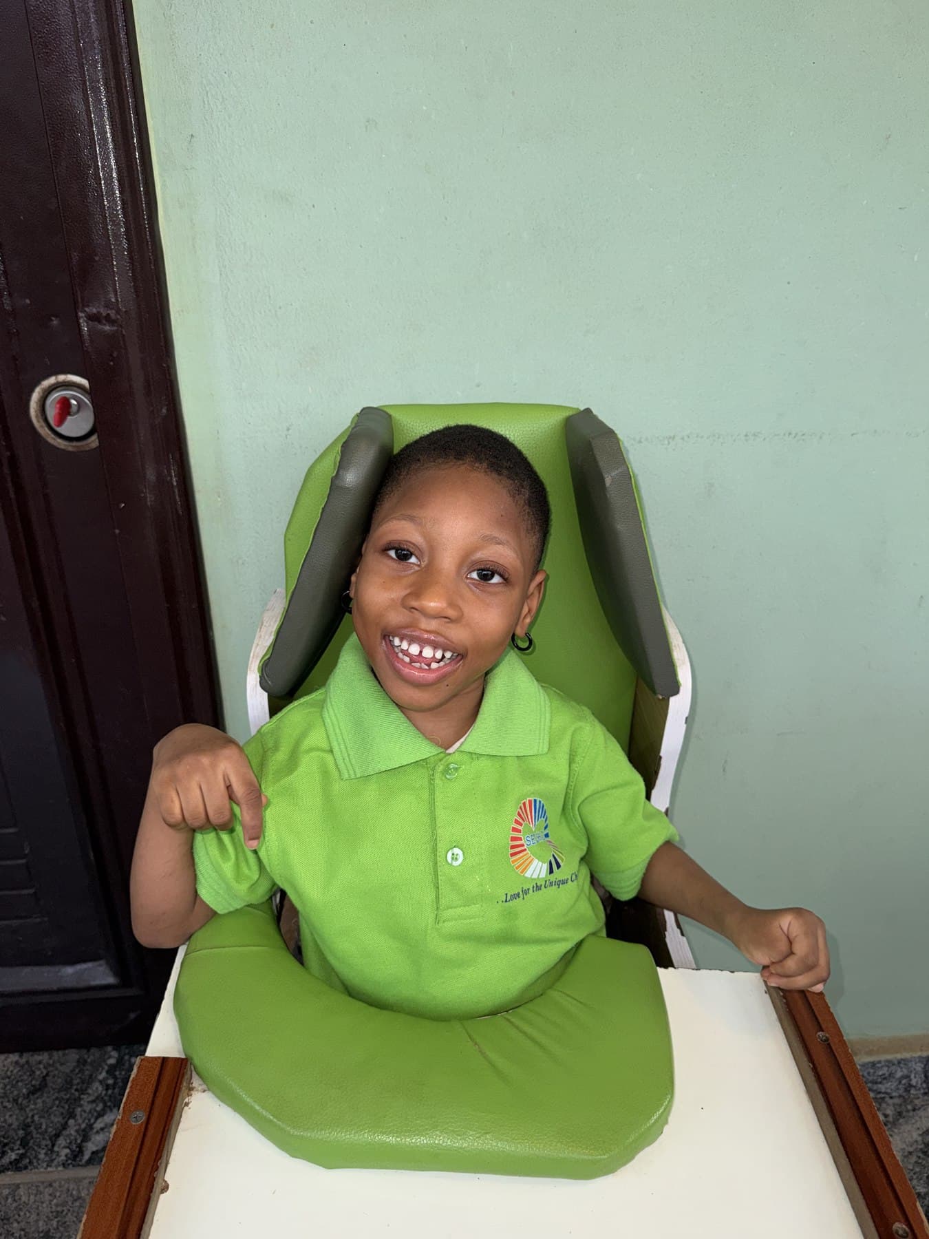 A smiling child at SECHILD's center, the kind of child a sponsorship supports