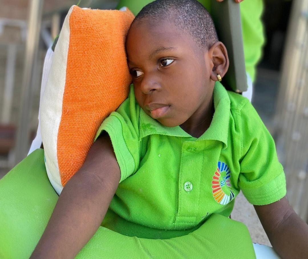 A child resting against a cushion at SECHILD's center