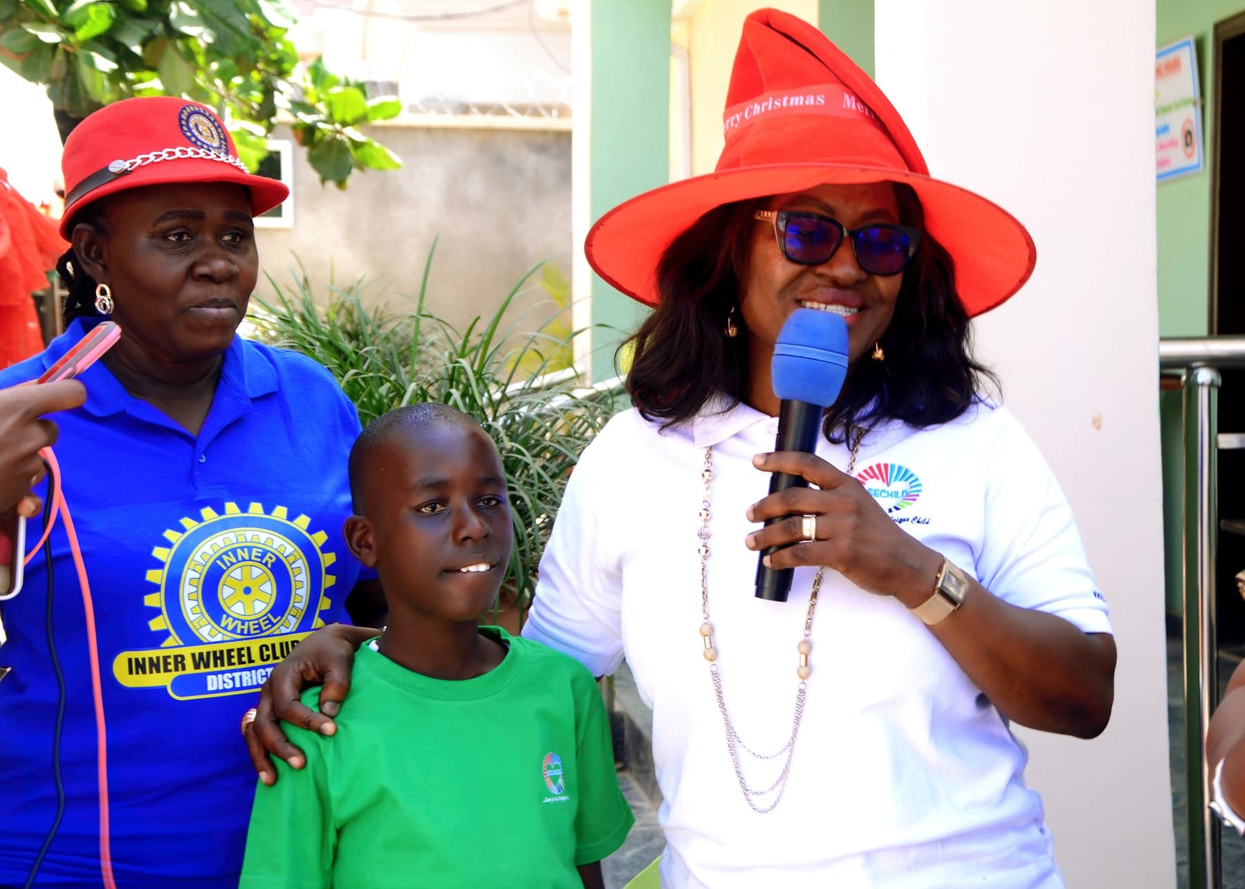SECHILD staff and a partner organization representative with a child at a community event
